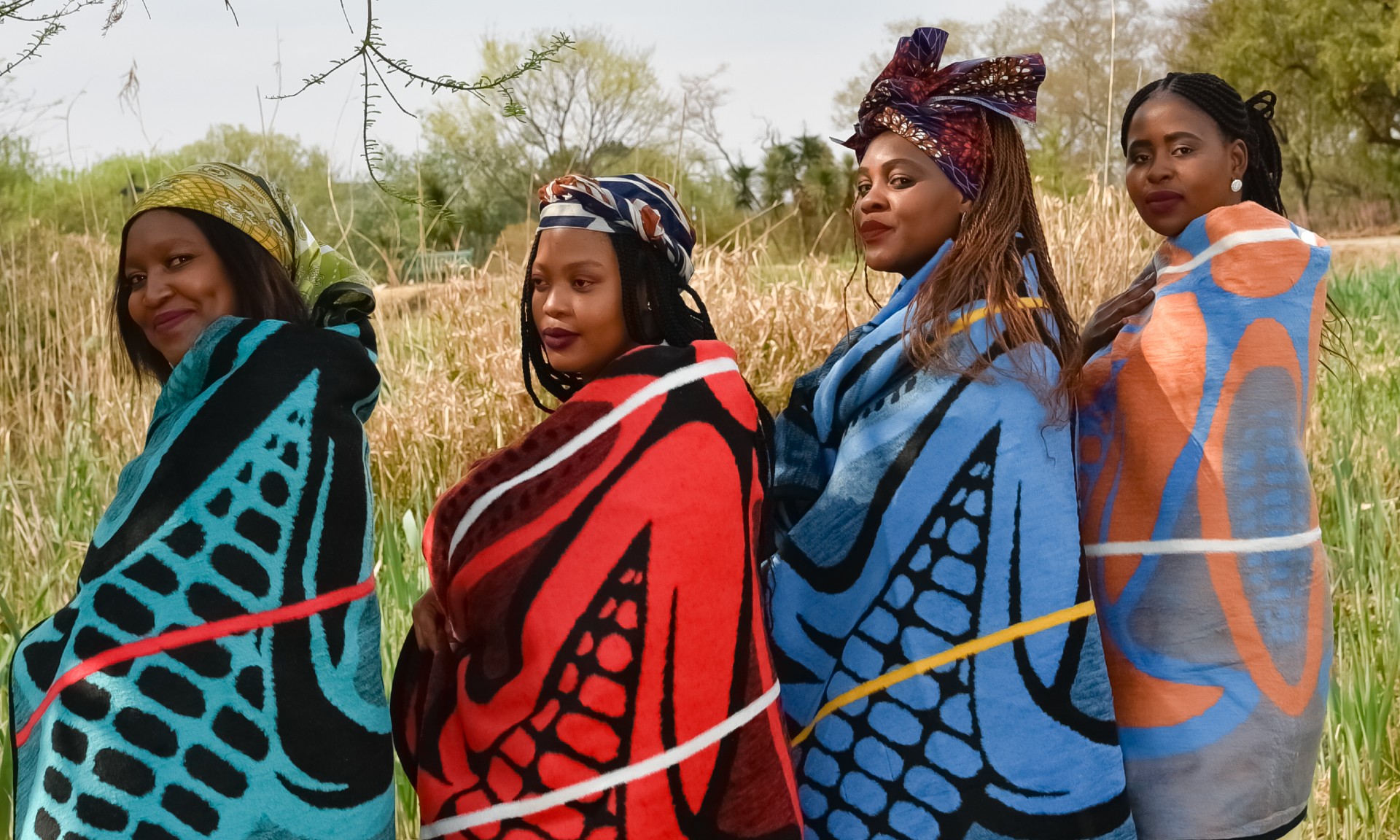 Four women wrapped in Basotho blankets
