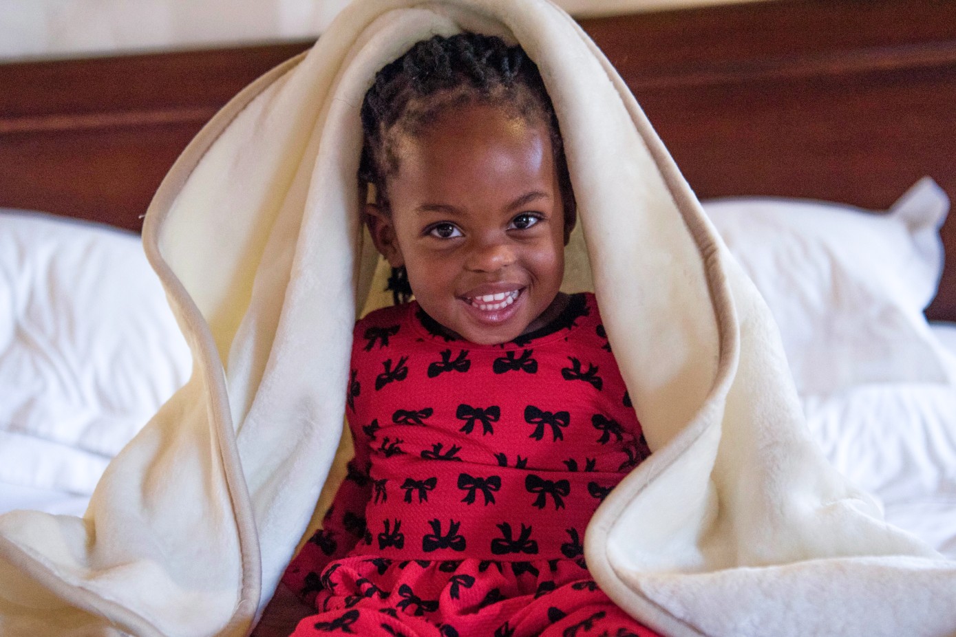 Toddler playing in a cosy baby blanket.